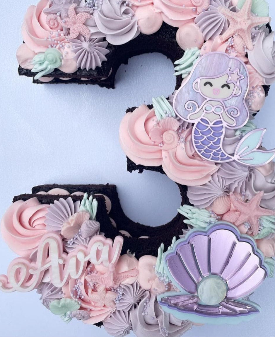 Decorative number cake with mermaid theme on a white background